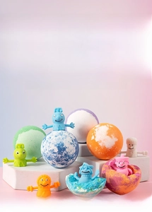 Detailed view of five colorful bath bombs and cute silicone animal finger toys for kids