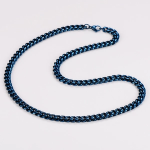 Detailed view of hip hop style blue stainless steel Cuban link chain on white background
