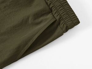 Detail of army green cargo shorts showing elastic waistband and reinforced stitching