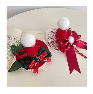 Detailed view of red velvet Christmas mini hat hair clips with lace and festive ribbons