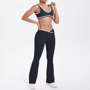 Detail of high-waist yoga pants with white V-shaped crossover waist and flared hem design