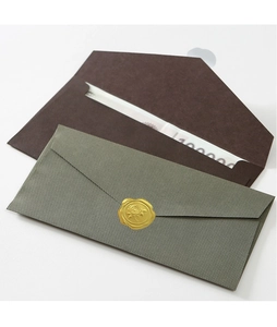Detail of olive green textured envelope with gold rose wax seal and brown gift voucher