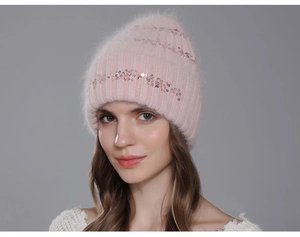 Close-up of light pink sequin knit beanie with fluffy rabbit hair texture for women