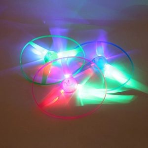 Close-up of LED glowing bamboo dragonfly toys in green, pink, and blue light effects