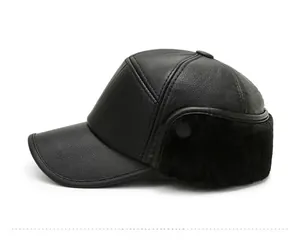 Side view of men's winter flat top cap with black faux leather and warm fur earflaps