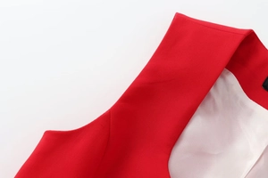 Macro shot of red double-breasted vest featuring high-density twill fabric and white lining