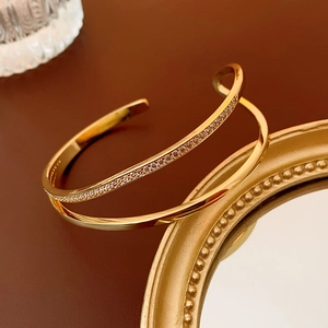 Detailed close-up of double-layer gold plated cuff bangle featuring pave-set zircon crystals