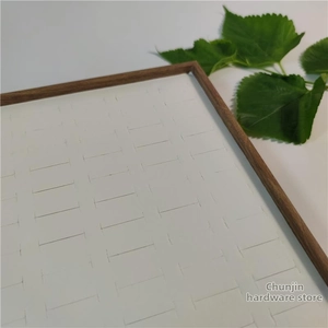Detail view of wooden jewelry display tray with slots for 100 rings and studs