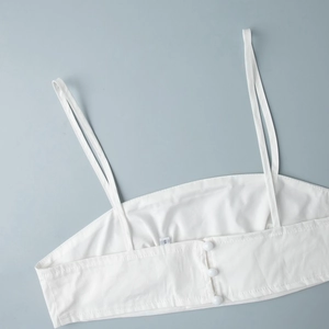 Détail du dos d'un caraco blanc en coton avec boutons et étiquette taille S