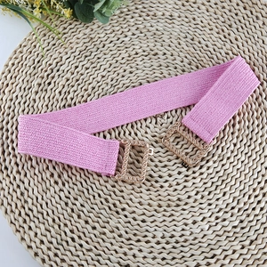 Detailed shot of pink elastic braided belt featuring gold-toned D-ring metal buckles
