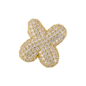 Detailed macro view of clover pendant with gold plating and paved cubic zirconia