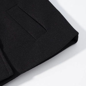 Detailed close-up of high-quality black textured wool fabric with premium stitching detail