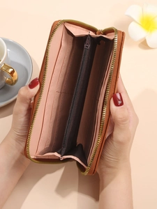 Brown leather women long wallet with pink interior showing card slots and zipper pocket