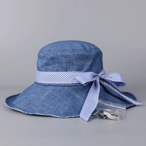 Blue sun hat with striped bow and adjustable windproof strap, linen texture detail