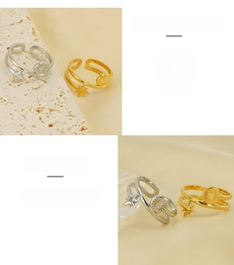 Detail of adjustable double-layer 18K gold and silver star rings with sunburst discs