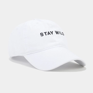 Close-up of Stay Wild embroidery on white washed cotton twill baseball cap with air vents