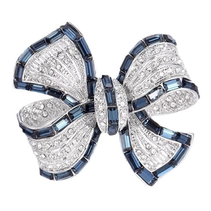 Elegant bow brooch with blue rectangular gem and white zircon crystals in silver finish