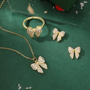 Detailed view of 925 silver bow jewelry set with zircon necklace, ring and earrings