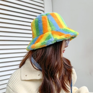 Detail shot of rainbow striped plush bucket hat showing faux fur texture and vibrant colors