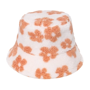 Detail of plush lamb wool bucket hat with orange flower pattern for winter warmth