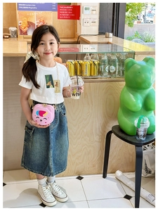 Pink cat-shaped silicone crossbody bag paired with a casual summer girl's denim outfit