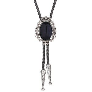 Detail of silver crown bolo tie with black oval stone and woven leather cord