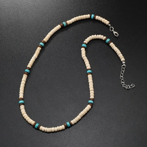 Detailed close-up of bohemian surf necklace with turquoise and wood beads and silver clasp