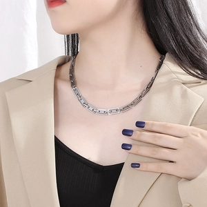 Polished silver geometric rectangle chain link necklace shown on a model neck