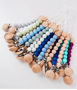 Silicone and beech wood pacifier clips in a colorful fan arrangement on white