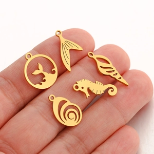 Five gold ocean charms including seahorse and whale tail for DIY jewelry making