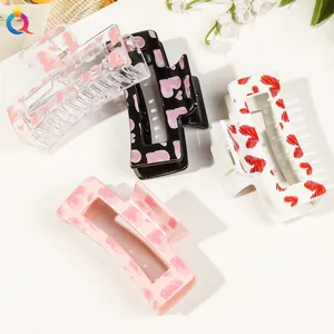 Detailed set of four rectangle heart pattern hair claws in pink, white and black colors