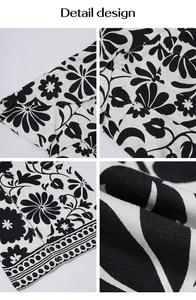 Detail design showing black and white floral prints on elegant wide leg jumpsuit fabric