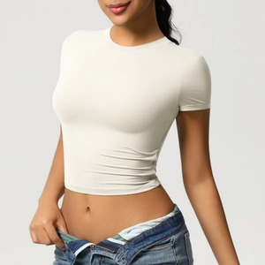 Close-up of cream white cropped yoga t-shirt showing slim fit and premium athletic fabric