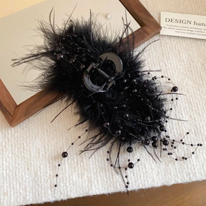 Black feather hair claw with beaded tassels in an irregular geometric vintage design