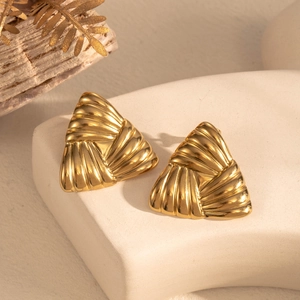 Golden geometric triangular earrings with textured folds on a minimalist stone display
