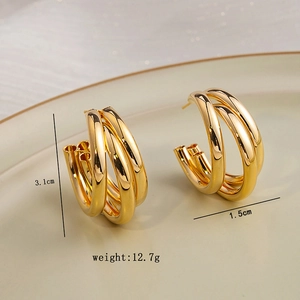 Close-up of golden geometric C-shape layered hoop earrings with 3.1cm height detail