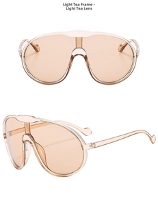 Detail view of oversized one-piece light tea sunglasses with wrap-around shield design
