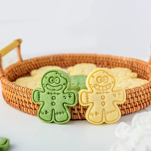 Gingerbread man cookie cutters for Christmas baking with cute cartoon faces and festive shapes