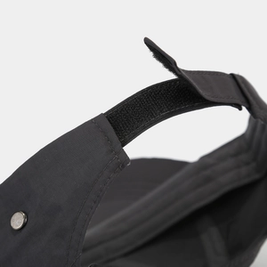Detail of adjustable Velcro strap on black quick-dry sport cap with silver rivets