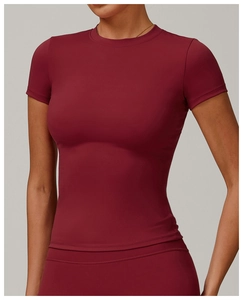 Close-up of wine red slim-fit quick-dry yoga t-shirt showing fabric texture and seams