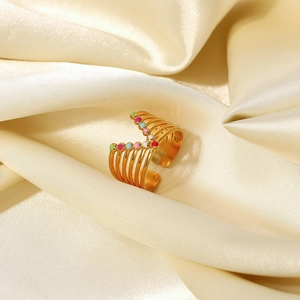Close-up of 18K gold plated multi-layer ring with colorful enamel dots on silk background