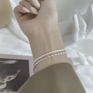 Close-up of a double-layer 925 sterling silver bracelet on wrist with elegant beaded details