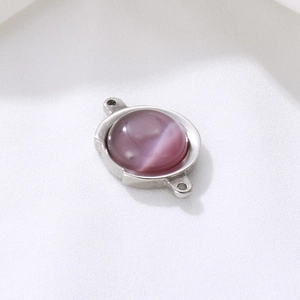 Detailed view of silver stainless steel round pendant with purple cat eye stone