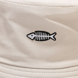 Beige cotton bucket hat with detailed fish bone embroidery and twill texture finish