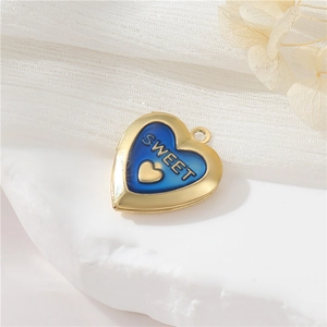 Macro detail of heart locket pendant with blue enamel and sweet gold engraving