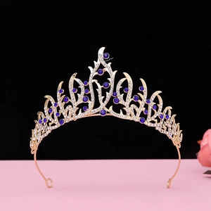 Detailed macro view of baroque gold crown with deep blue crystals and rhinestones