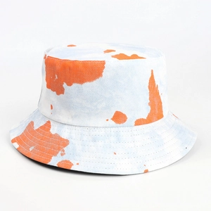 Detailed close-up showing the orange and blue tie-dye texture on the cotton bucket hat
