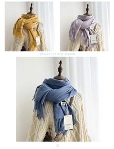 Detail of soft solid color scarves with fringe tassels in yellow, purple and denim blue