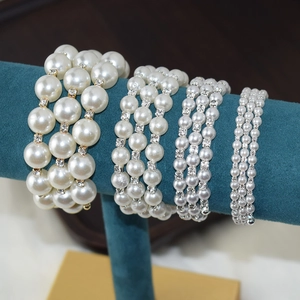 Close-up of multi-layer pearl bracelets with rhinestones on a jewelry display stand
