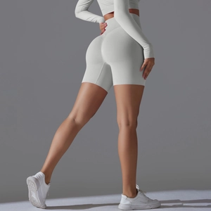 Close-up of seamless light gray high-waisted yoga shorts with peach lift contouring